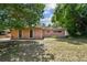 Ranch style home with a pink exterior and spacious yard at 1618 Valencia St, Clearwater, FL 33756