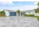 Charming light blue home with a large stone driveway at 5690 Bayview Dr, Seminole, FL 33772