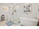 Spa-like bathroom with soaking tub, walk-in shower, and frameless glass enclosure at 5690 Bayview Dr, Seminole, FL 33772