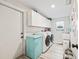 Laundry room with washer, dryer, and a retro refrigerator at 5690 Bayview Dr, Seminole, FL 33772