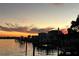 Stunning sunset view over calm water with boats at a marina at 5690 Bayview Dr, Seminole, FL 33772