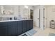 Elegant bathroom featuring dark vanity, marble countertops, and updated fixtures at 5690 Bayview Dr, Seminole, FL 33772