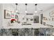 Modern kitchen with white cabinets, quartz countertops, and breakfast bar at 5690 Bayview Dr, Seminole, FL 33772