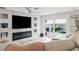Living room features a marble fireplace and sliding doors to the pool area at 5690 Bayview Dr, Seminole, FL 33772