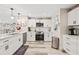 Modern white kitchen with stainless steel appliances and quartz countertops at 5690 Bayview Dr, Seminole, FL 33772