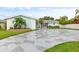 Stunning home exterior with a stone driveway and landscaping at 5690 Bayview Dr, Seminole, FL 33772