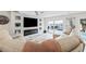 Living room with sectional sofa, fireplace, and water views at 5690 Bayview Dr, Seminole, FL 33772
