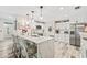 Updated kitchen boasts white cabinets, quartz countertops, and island seating at 5690 Bayview Dr, Seminole, FL 33772