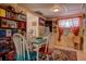 Cozy dining area with a teal table, colorful chairs, and ample bookshelf storage at 6470 64Th N Ave, Pinellas Park, FL 33781