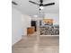Spacious living area with light wood flooring and a stone accent wall at 751 90Th N Ave, St Petersburg, FL 33702