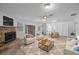 Living room with stone fireplace and seating area at 751 90Th N Ave, St Petersburg, FL 33702