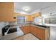Bright kitchen features wood cabinets, stainless steel appliances, and a breakfast bar at 751 90Th N Ave, St Petersburg, FL 33702