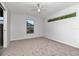 Minimalist bedroom with ample light featuring neutral walls and carpet at 102 Shore W Dr, Oldsmar, FL 34677