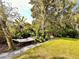 Serene backyard featuring a hammock, lush greenery, mature trees and tranquil space at 1503 Edna Ave Nw, Largo, FL 33770