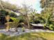 Lush backyard oasis featuring a hammock, mature trees, and serene landscaping at 1503 Edna Ave Nw, Largo, FL 33770