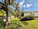 Spacious backyard with lush greenery, mature trees, and a wooden fence at 1503 Edna Ave Nw, Largo, FL 33770