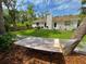 This backyard is fully fenced, grassy, and has a hammock and outdoor furniture at 1503 Edna Ave Nw, Largo, FL 33770