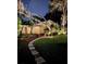 Nighttime backyard showcasing the hammock, lush lawn, and outdoor lighting at 1503 Edna Ave Nw, Largo, FL 33770