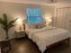 Bright bedroom with a large window and closet space, complemented by modern nightstands at 1503 Edna Ave Nw, Largo, FL 33770