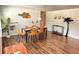 Open dining room with hardwood floors, a dining table with seating for six, and modern decor at 1503 Edna Ave Nw, Largo, FL 33770