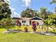 Charming home with well-manicured lawn, beautiful landscaping, and a welcoming entrance at 1503 Edna Ave Nw, Largo, FL 33770