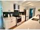 Modern kitchen with white cabinets, stainless steel appliances, and a stylish backsplash at 1503 Edna Ave Nw, Largo, FL 33770