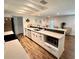 Open-concept kitchen featuring stainless steel appliances and breakfast bar with seating at 1503 Edna Ave Nw, Largo, FL 33770