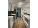 Modern kitchen with sleek white cabinetry, stainless steel appliances, and stylish backsplash at 1503 Edna Ave Nw, Largo, FL 33770