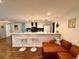 Open-concept living area with modern seating and updated kitchen featuring breakfast bar and stylish decor at 1503 Edna Ave Nw, Largo, FL 33770
