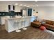Open-concept living space featuring modern bar stools and seamless connection to the kitchen at 1503 Edna Ave Nw, Largo, FL 33770