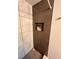 Close-up of a tiled shower featuring convenient recessed storage and stylish fixtures at 1503 Edna Ave Nw, Largo, FL 33770