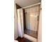 Modern bathroom shower featuring marble-look tiling, bronze fixtures, and mosaic tile floor at 1503 Edna Ave Nw, Largo, FL 33770