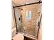 Modern bathroom shower featuring unique tile, black hardware, built in shelves and glass doors at 1503 Edna Ave Nw, Largo, FL 33770