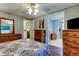 Bright bedroom with a double bed, wooden furniture, and access to another room at 192 Blue Marlin Dr, Oldsmar, FL 34677