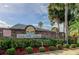 Gull Aire Village entrance with brick wall and landscaping at 192 Blue Marlin Dr, Oldsmar, FL 34677