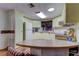 Galley style kitchen with light cabinets and a curved kitchen island at 192 Blue Marlin Dr, Oldsmar, FL 34677