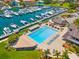 Resort-style pool with lounge chairs and a marina in the background at 5966 Bayview S Cir, St Petersburg, FL 33707