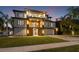 Stunning modern home illuminated at night with a large yard at 5966 Bayview S Cir, St Petersburg, FL 33707