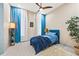 Cozy bedroom with a blue accent wall and plenty of natural light at 5966 Bayview S Cir, St Petersburg, FL 33707