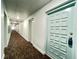 Building hallway with carpet flooring and light-colored walls at 2700 Bayshore Blvd # 3212, Dunedin, FL 34698