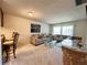 Bright living room featuring a comfy sofa and dining area at 2700 Bayshore Blvd # 3212, Dunedin, FL 34698