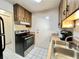 Kitchen with wood cabinets, stainless steel appliances, and double sink at 2700 Bayshore Blvd # 3212, Dunedin, FL 34698