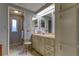 Bathroom with double vanity, shower, and linen storage at 192 Blue Marlin Dr, Oldsmar, FL 34677
