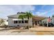 Single-wide mobile home with covered carport and tropical landscaping at 192 Blue Marlin Dr, Oldsmar, FL 34677