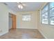 A bedroom features wood-look floors, neutral paint, a ceiling fan, and a built in closet at 5210 Newton S Ave, Gulfport, FL 33707