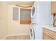 Laundry area with stacked washer and dryer, cabinet, and small window at 5210 Newton S Ave, Gulfport, FL 33707