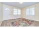 Inviting living room with wood floors, fresh paint, natural light, and a vibrant rug for a warm and welcoming ambiance at 5210 Newton S Ave, Gulfport, FL 33707