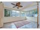Enclosed sunroom with multiple windows and a ceiling fan at 5210 Newton S Ave, Gulfport, FL 33707