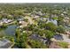 Serene aerial view of a community with mature trees, winding streets, and a nearby lake, offering a tranquil setting at 5841 Bay Pines Lakes Blvd, St Petersburg, FL 33708