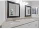 Bathroom featuring double sink with granite countertop and decorative mirrors at 5841 Bay Pines Lakes Blvd, St Petersburg, FL 33708